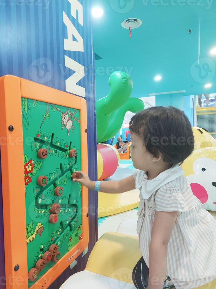 Positive activities for children playing in an indoor area filled with toy facilities and a place where they can find unlimited creativity photo