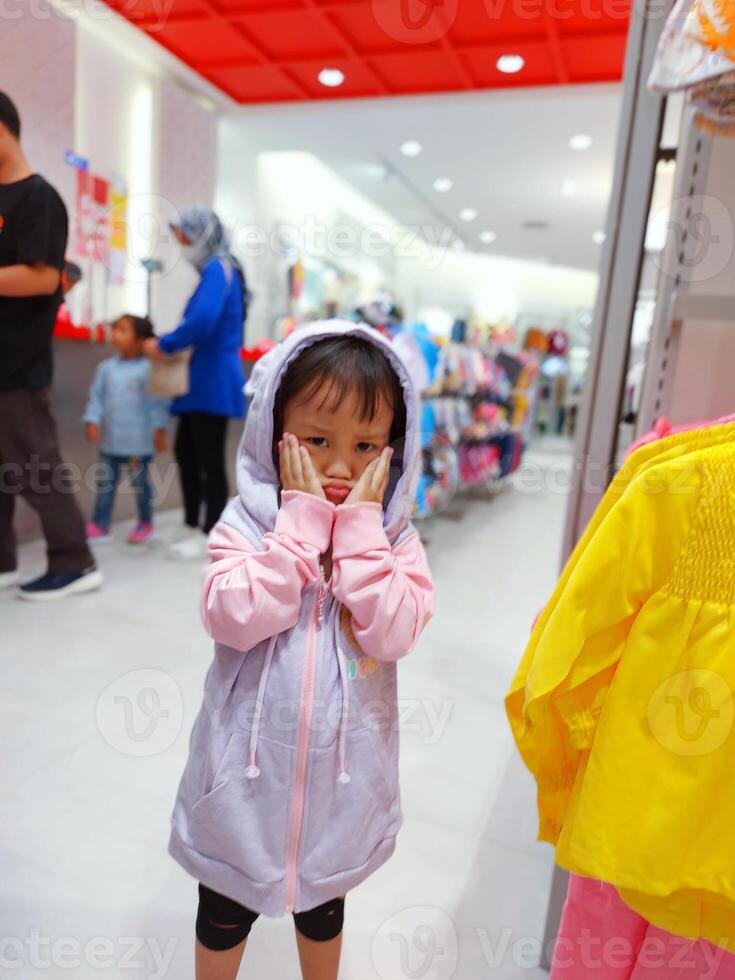 Children play in the children's playground in the mall area enjoying the holiday period, doing positive activities and having fun photo