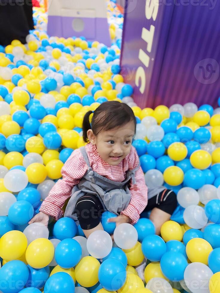 Children play in the children's playground in the mall area enjoying the holiday period, doing positive activities and having fun photo
