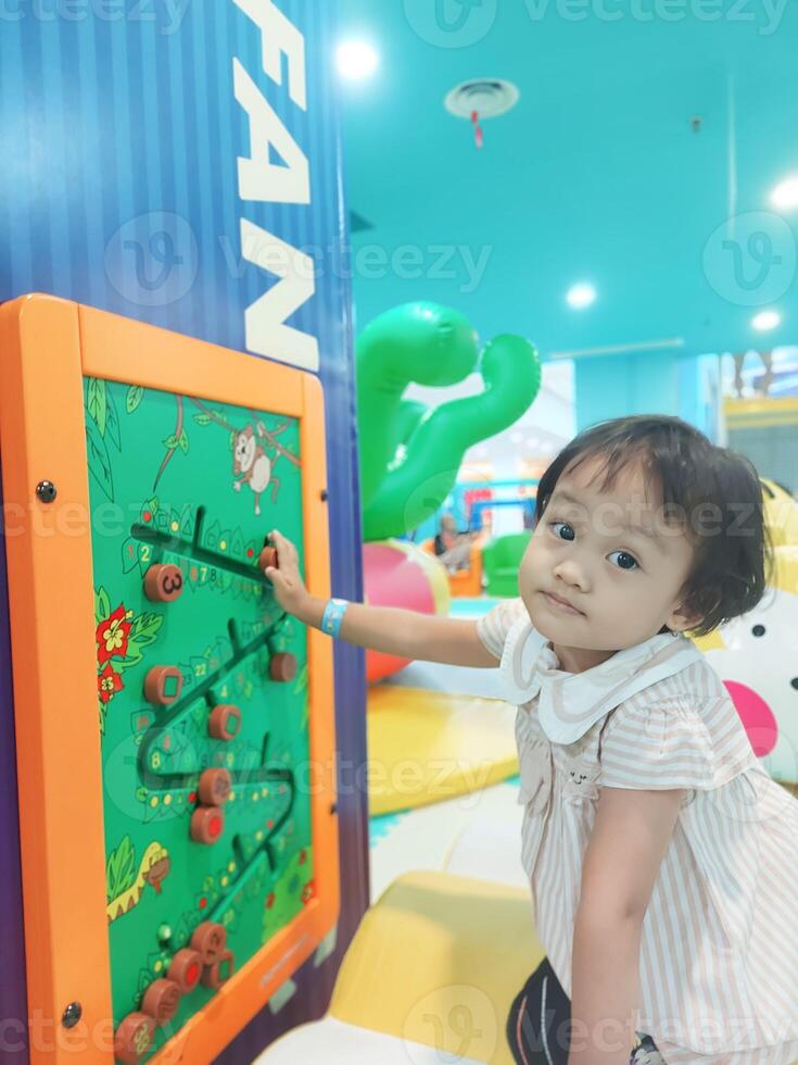 Positive activities for children playing in an indoor area filled with toy facilities and a place where they can find unlimited creativity photo