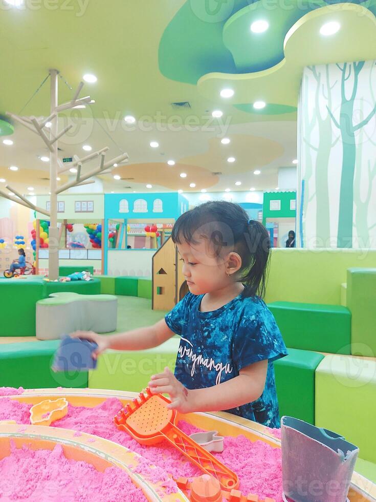 Positive activities for children playing in an indoor area filled with toy facilities and a place where they can find unlimited creativity photo