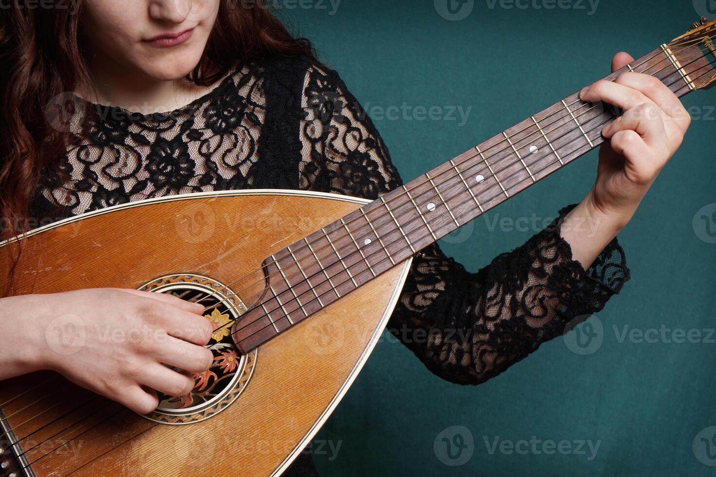 female playing lute string instrument photo