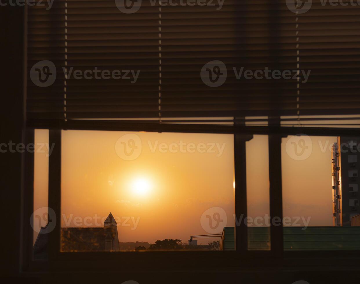 sun setting seen through the window photo