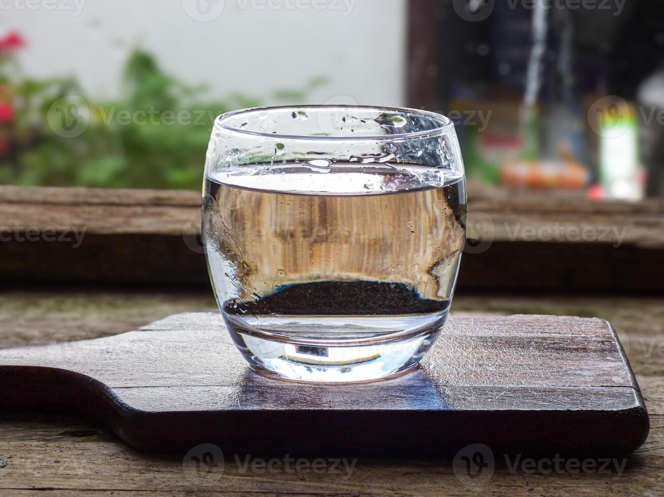 a glass of clean water on the kitchen table in a transparent glass photo