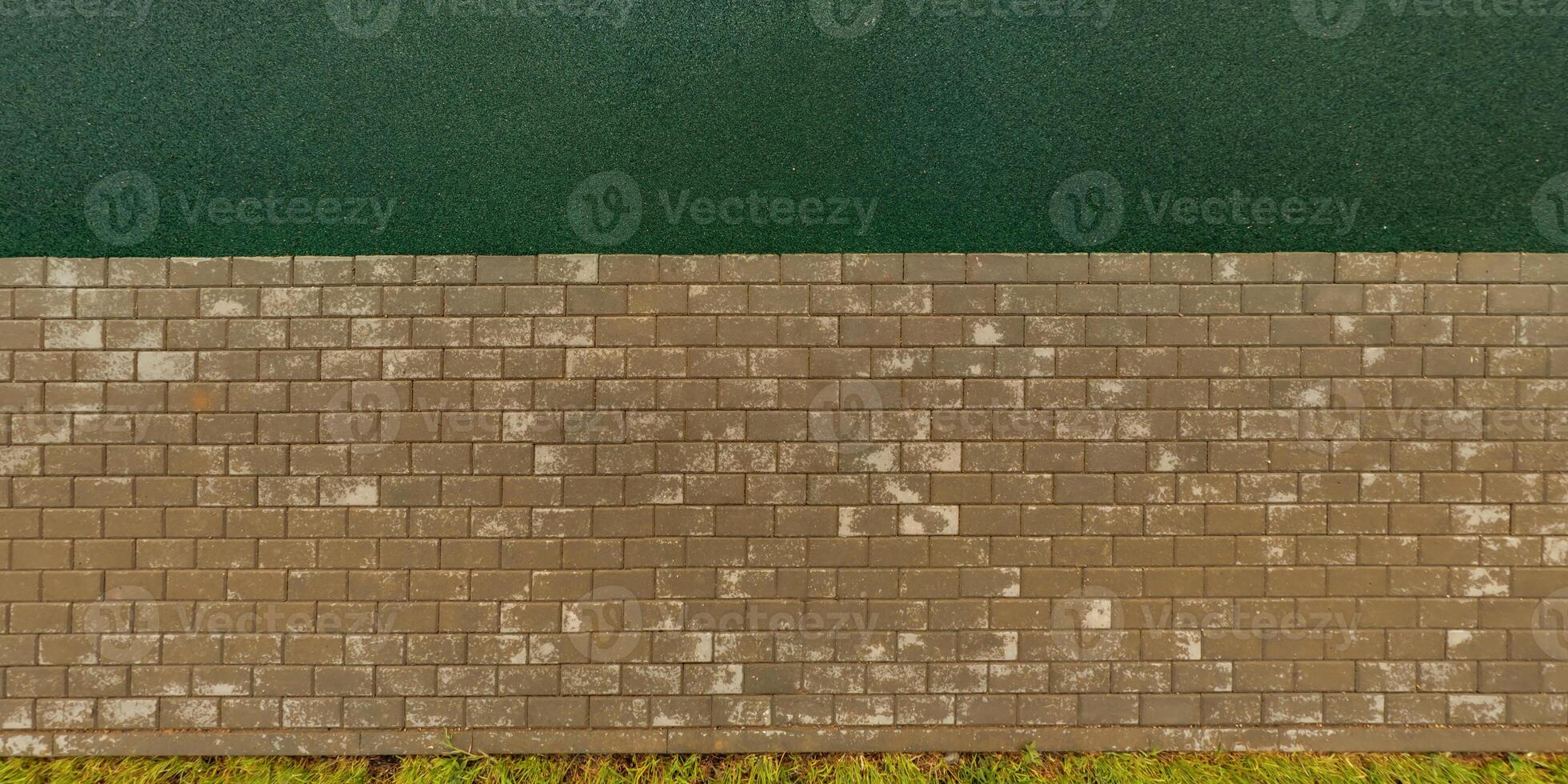 top view of the surface of wet paving slabs and pedestrian footpath after rain photo