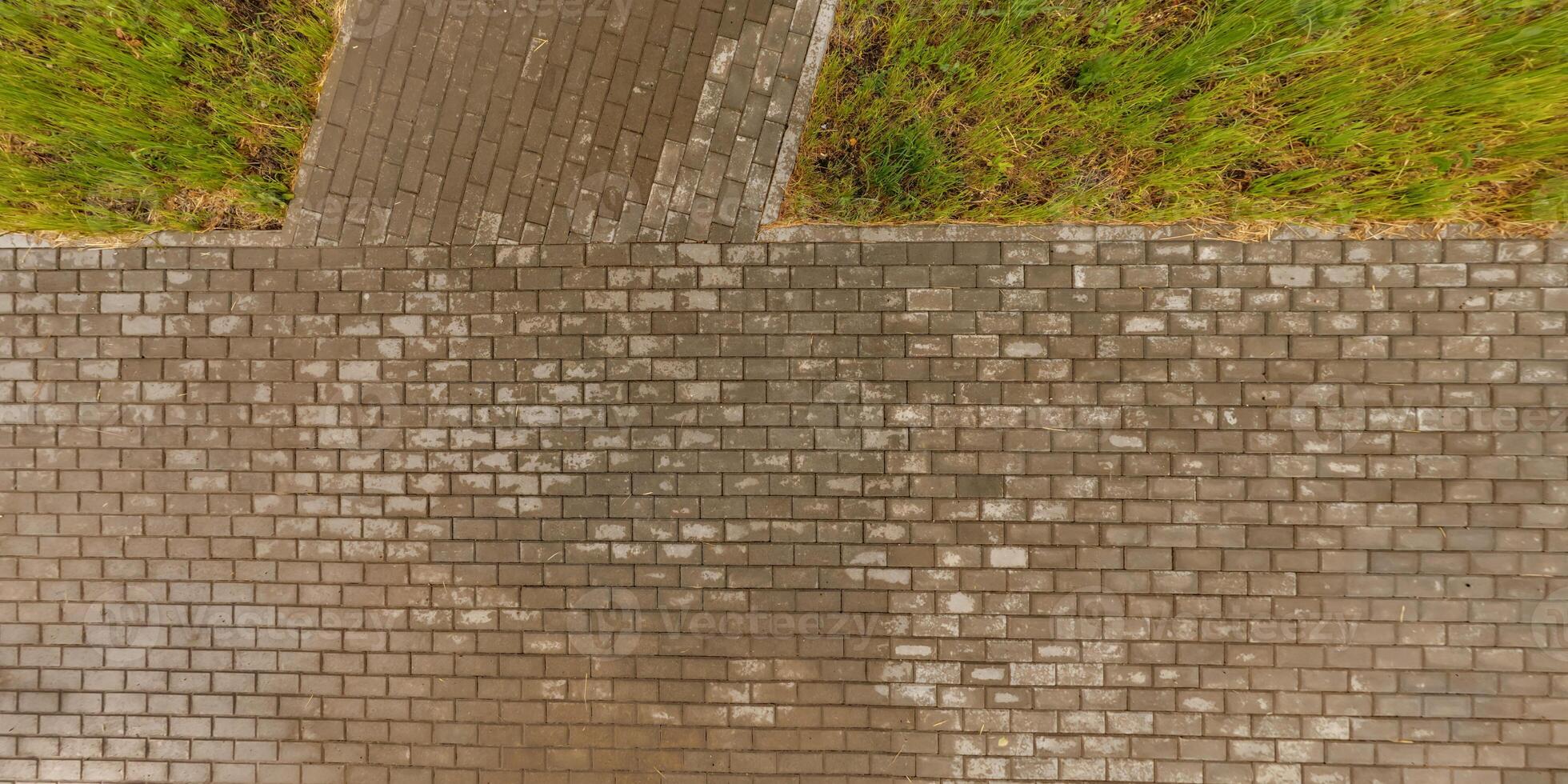 top view of the surface of wet paving slabs and pedestrian footpath after rain photo