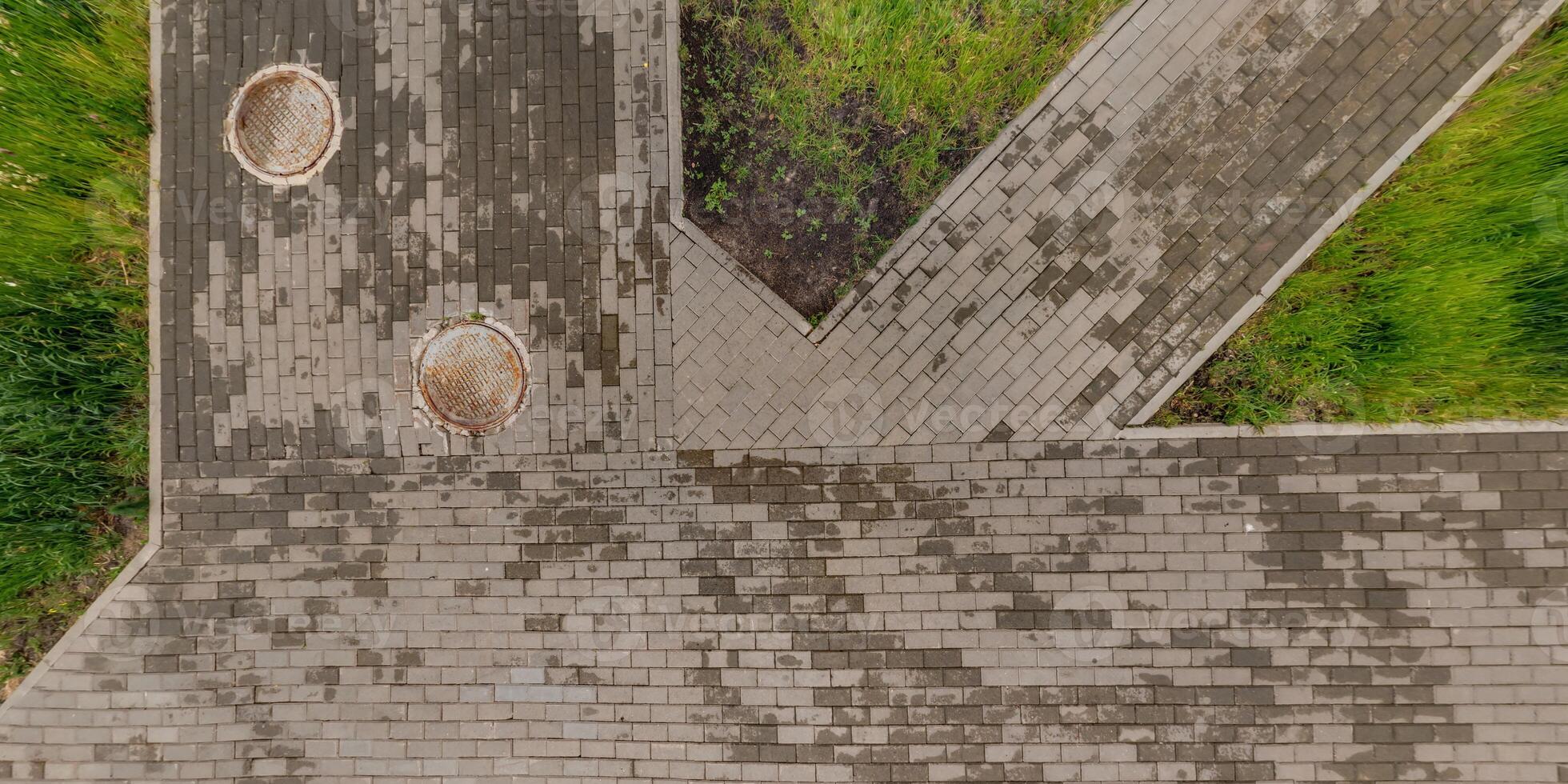 top view of the surface of wet paving slabs and pedestrian footpath after rain photo