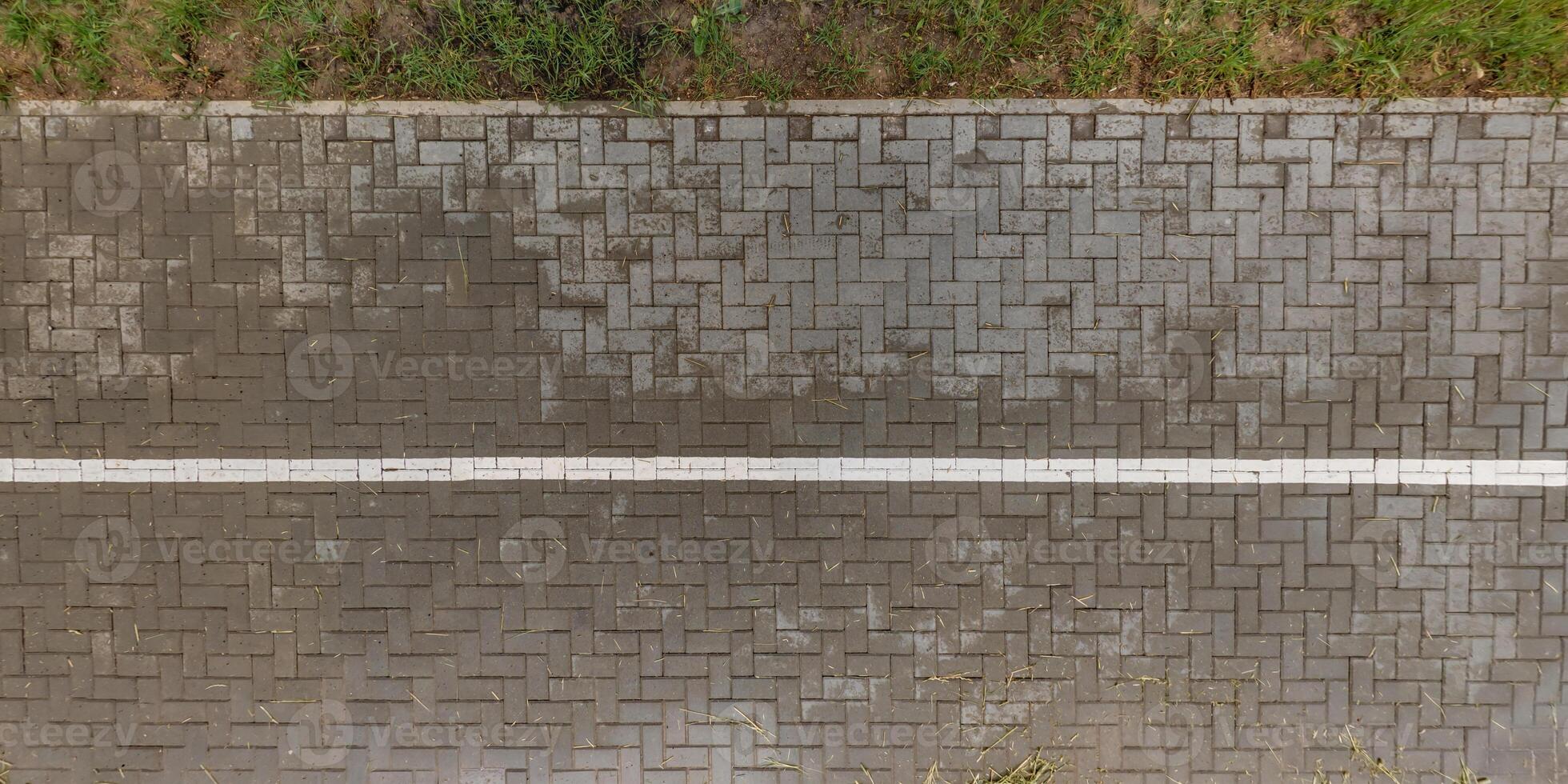 top view of the surface of wet paving slabs and pedestrian footpath after rain photo