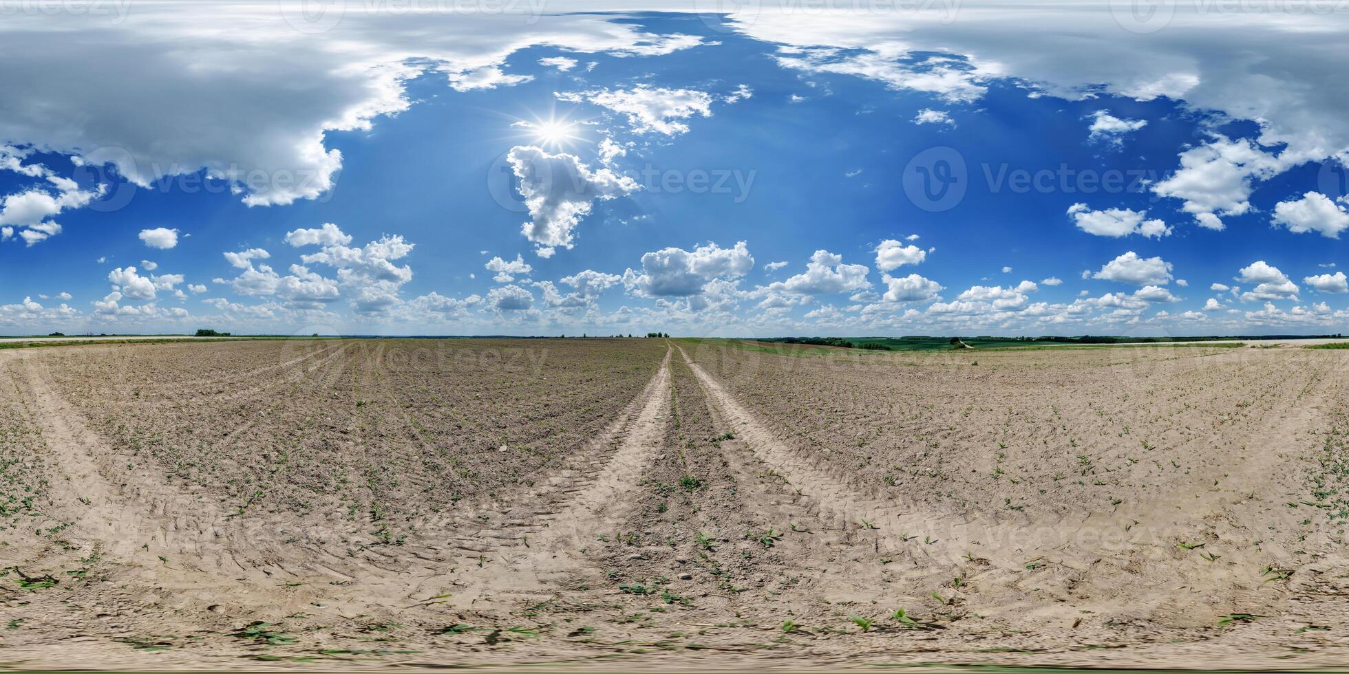 360 hdri panorama view on no traffic gravel road among fields in spring day with beautiful clouds in equirectangular full seamless spherical projection, ready for VR AR photo
