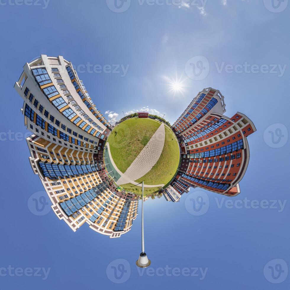 abstract swirling tiny planet spherical panorama of multi-storey buildings of skyscrapers of a residential complex in the form of a butterfly, bugs, crabs in blue sky photo