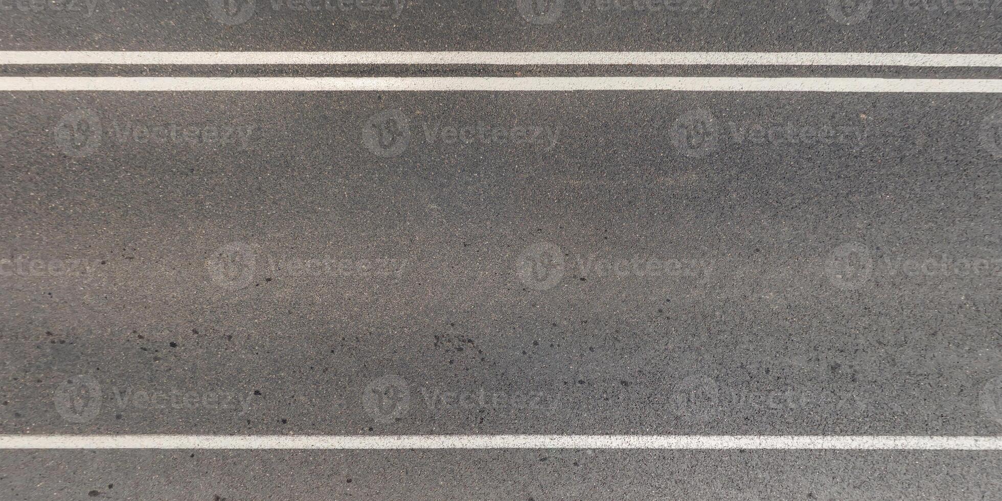 view from above on texture of asphalt road with cracks photo