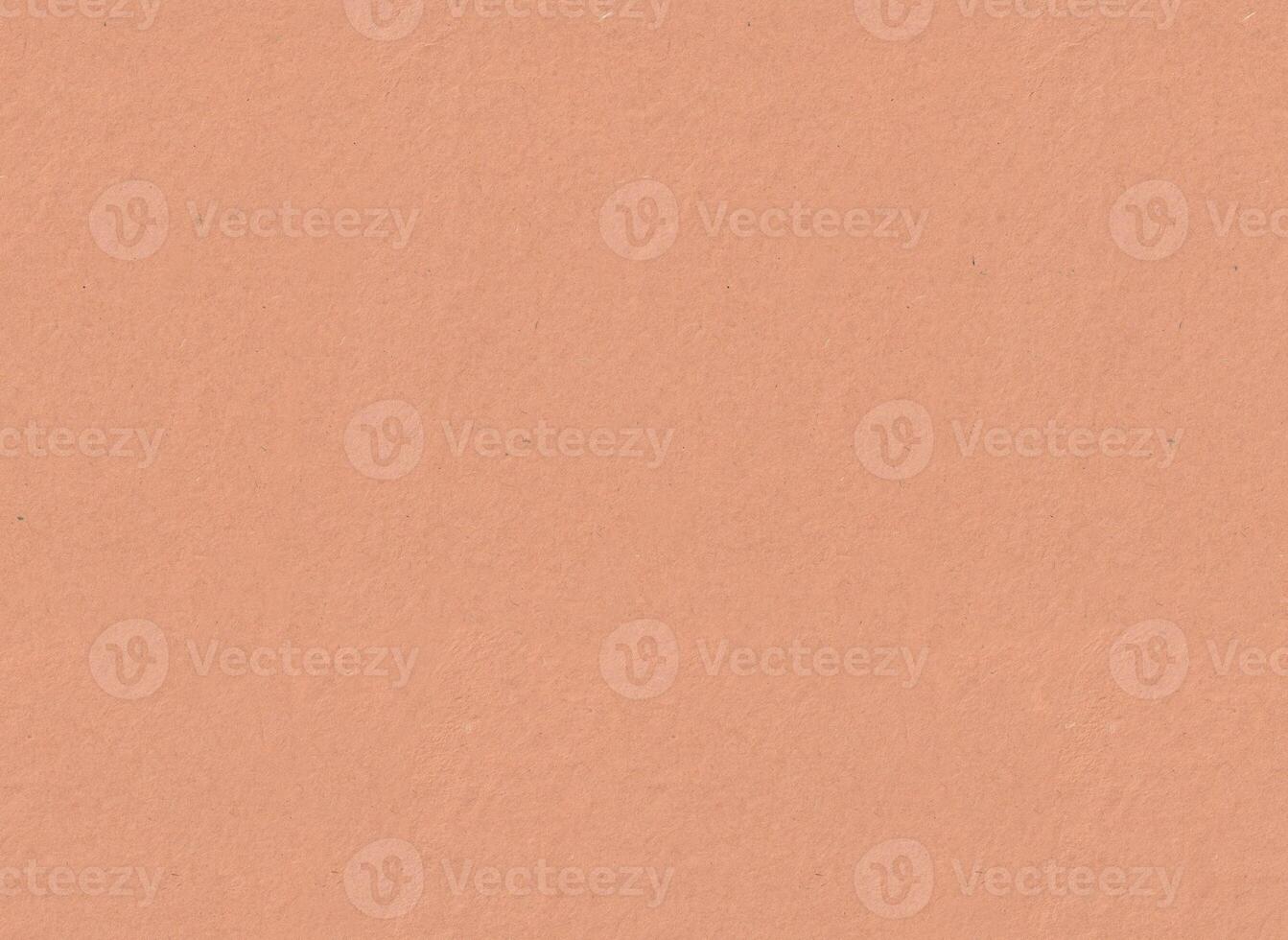 Earth colored peach salmon Rhesho paper texture. Seamless handmade craft recycled paper background surface. Natural pigment applied by hand on one page side. 120gsm photo