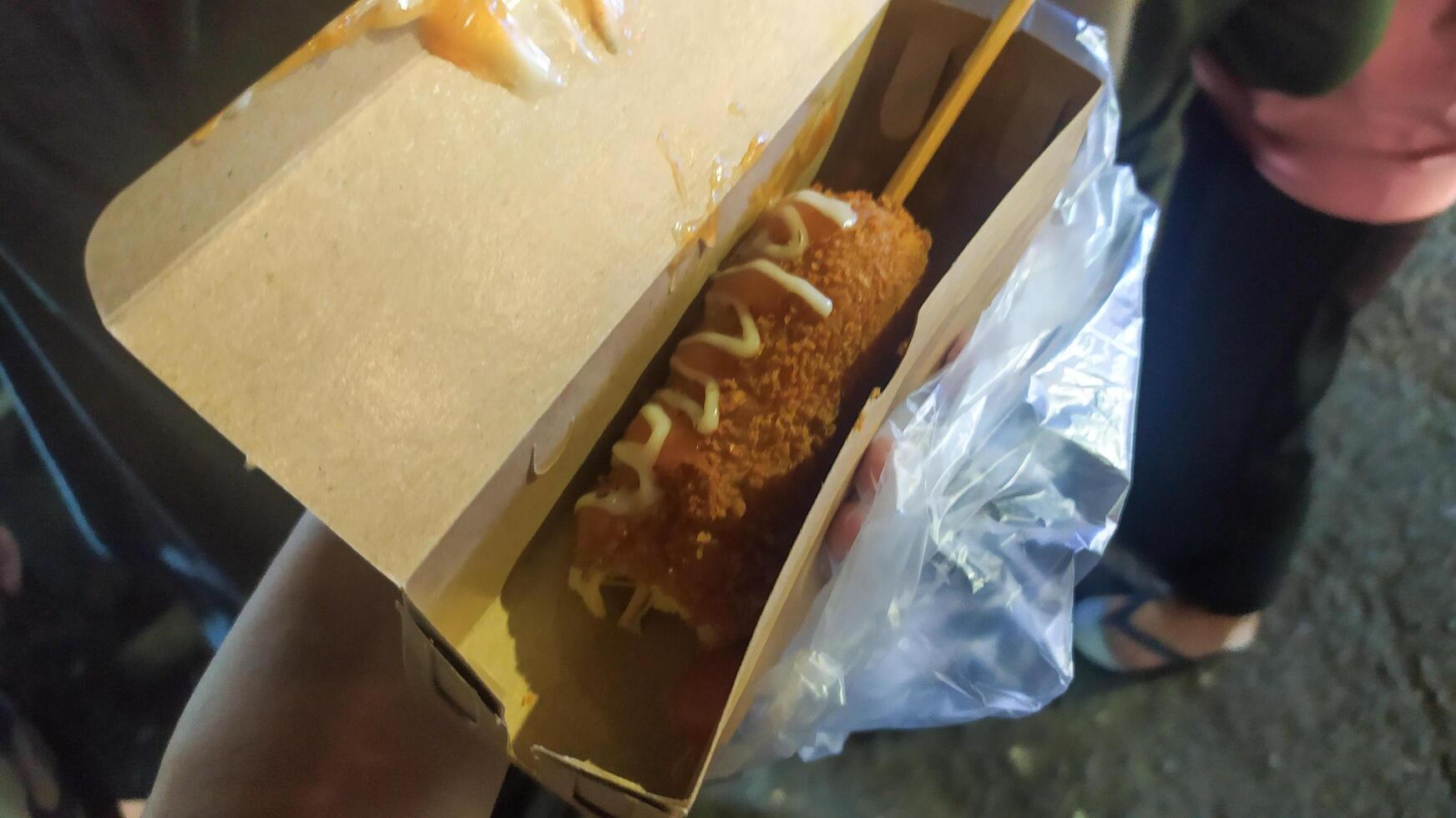 a warm corndog just bought at a festival photo