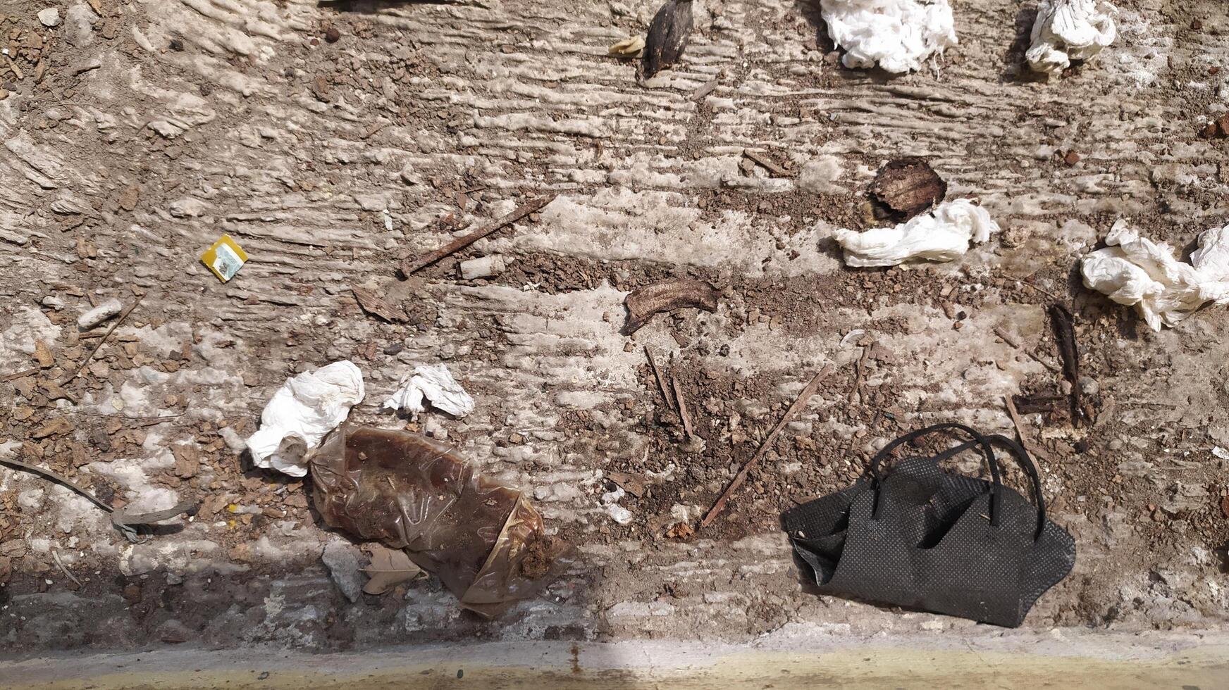 The ground surface is full of plastic and tissue waste accompanied by dust that sticks to the floor. very suitable for campaign backgrounds photo