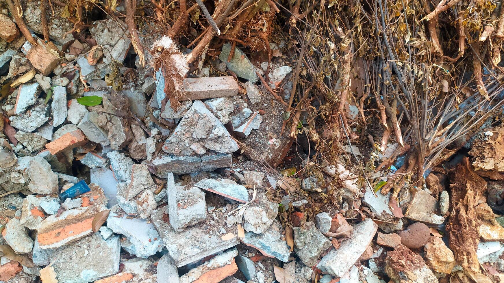 a pile of destroyed building blocks, placed somewhere. You can clearly see the damaged bricks on the building walls and foundation photo