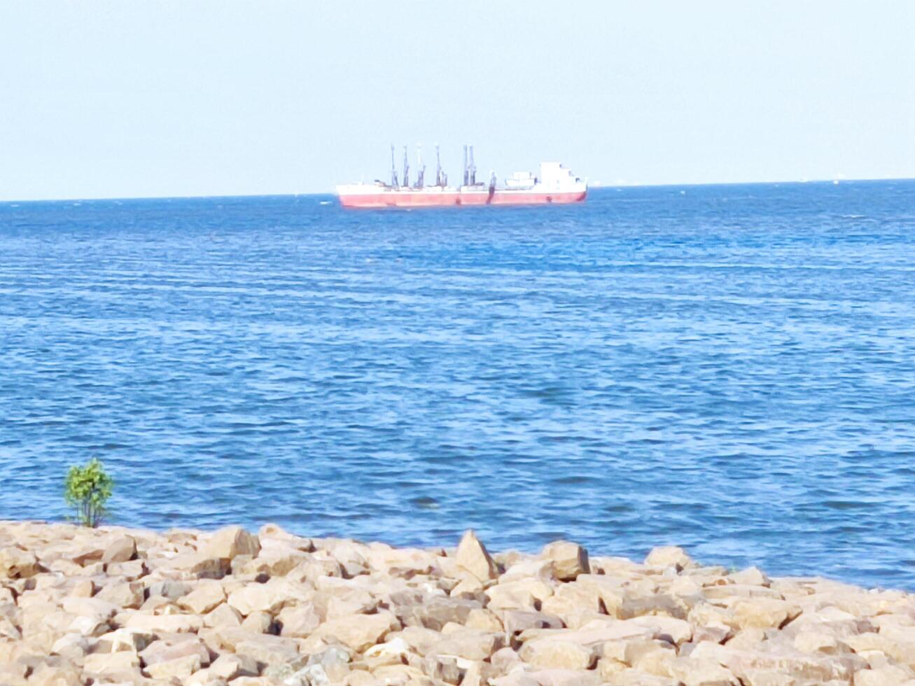 sea view in the afternoon with a passing ship photo