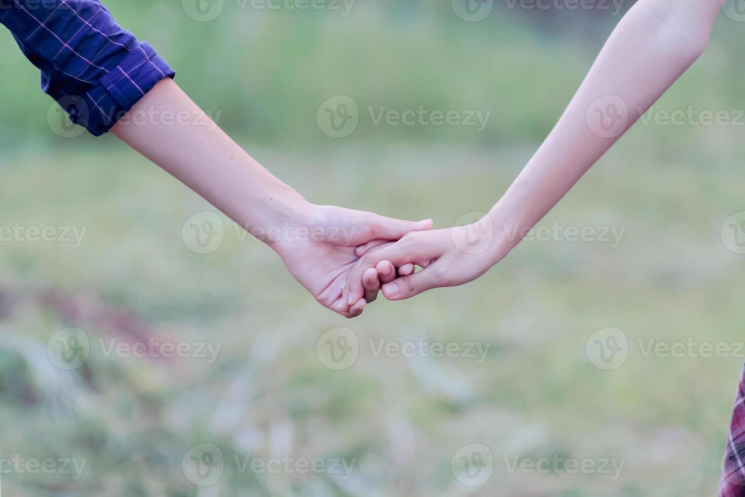 lgbtq couples hold hands to express their love and show couples confidence in their love for each other on their big day and forever Ideas for showing love and care for lgbtq couples by holding hands. photo