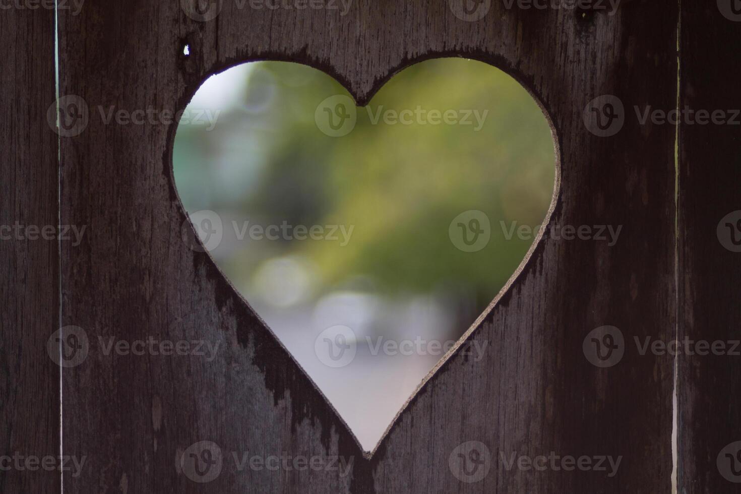 background is a heart-shaped piece of wood, which means I love you and is also a symbol of love and friendship for one another. A heart-shaped stencil on the background was used to decorate the venue. photo
