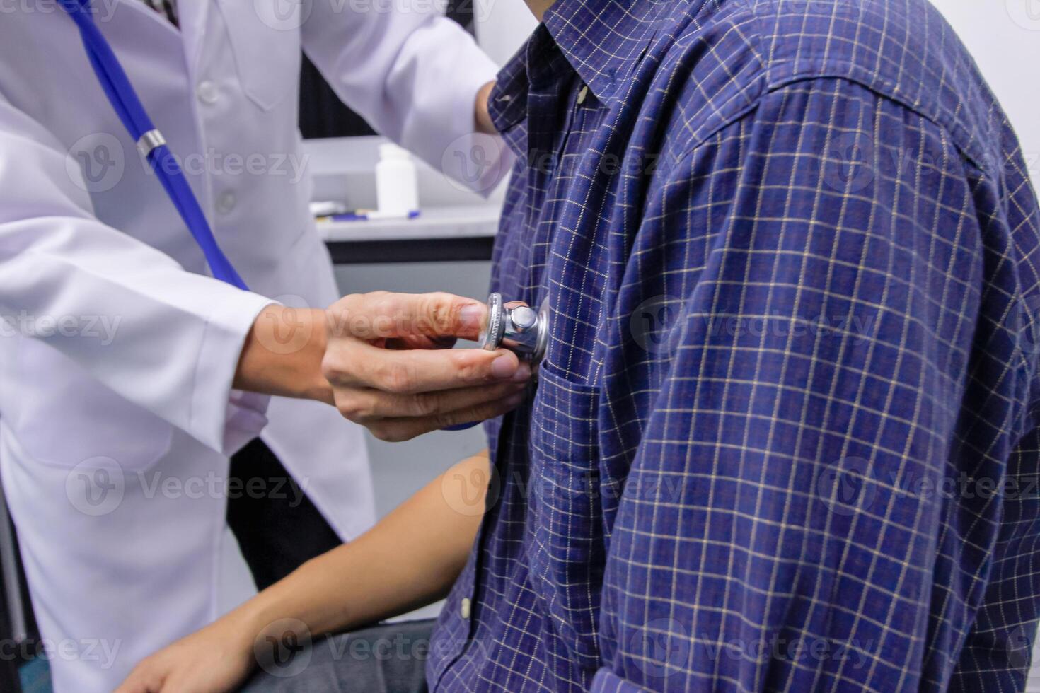 Doctors use stethoscope to listen patient heartbeat to find faults in heart disease. Doctors use stethoscope to listen patient heart rate to gather information diagnose disease and provide treatment. photo