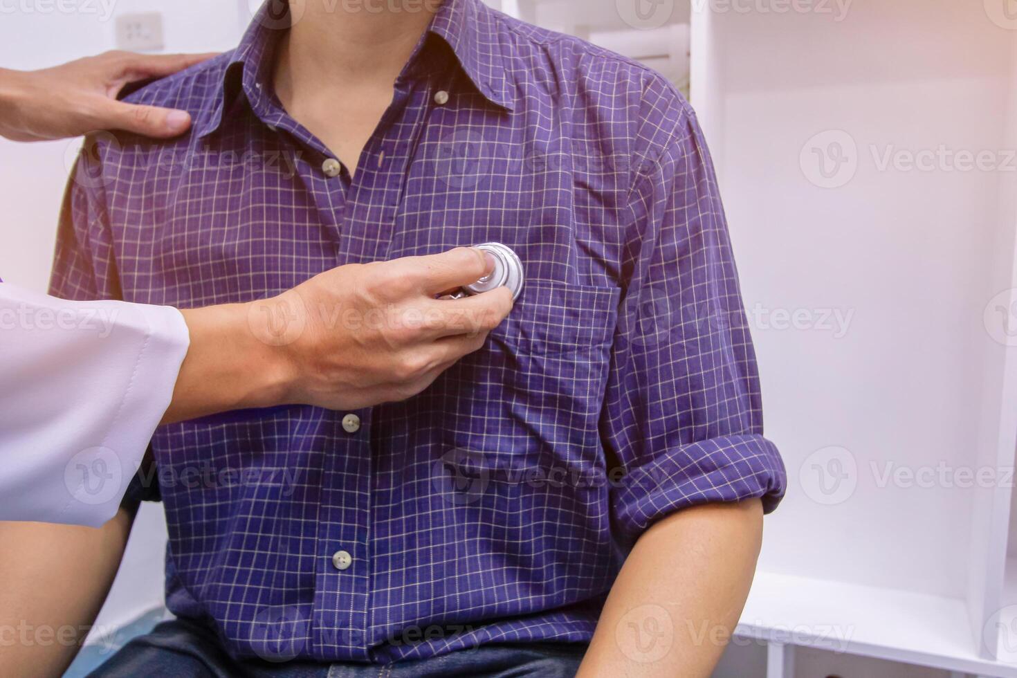 Doctors use stethoscope to listen patient heartbeat to find faults in heart disease. Doctors use stethoscope to listen patient heart rate to gather information diagnose disease and provide treatment. photo