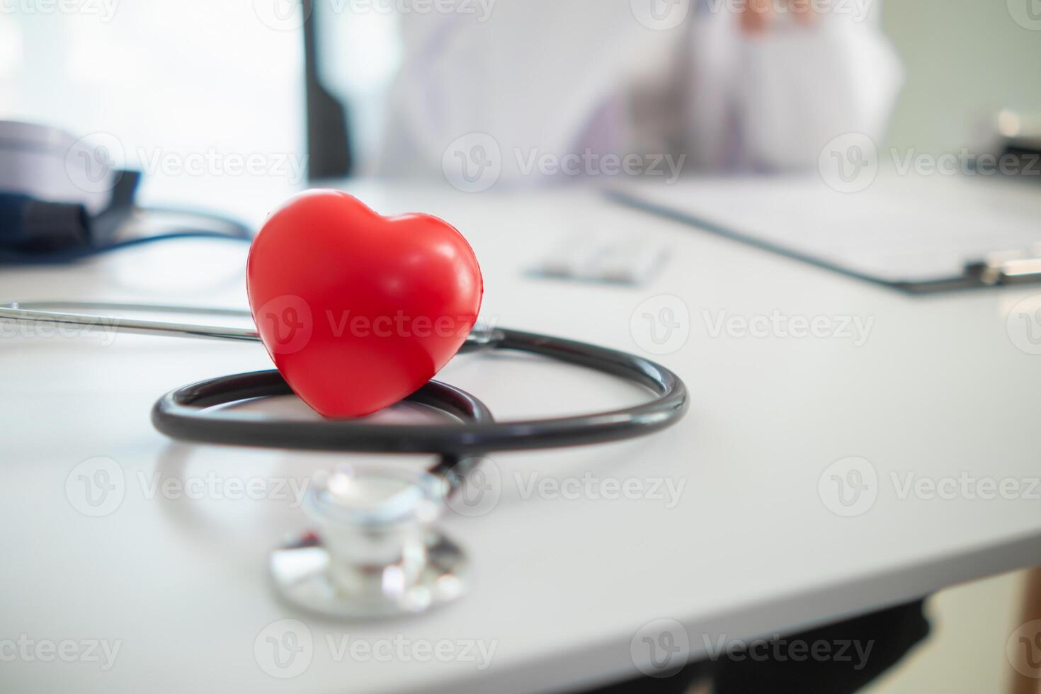 Doctors use stethoscope to listen patient heartbeat to find faults in heart disease. Doctors use stethoscope to listen patient heart rate to gather information diagnose disease and provide treatment. photo