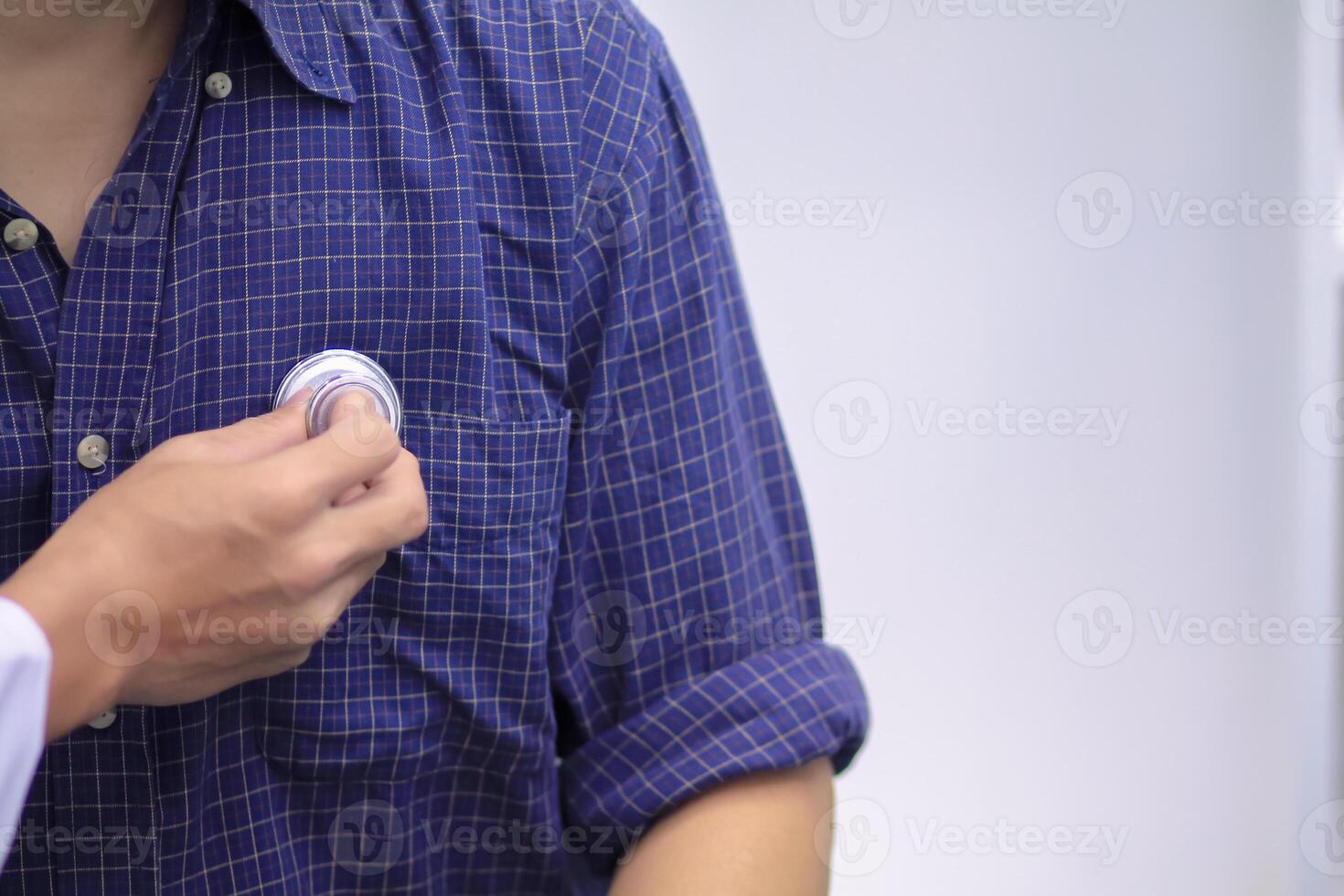 Doctors use stethoscope to listen patient heartbeat to find faults in heart disease. Doctors use stethoscope to listen patient heart rate to gather information diagnose disease and provide treatment. photo
