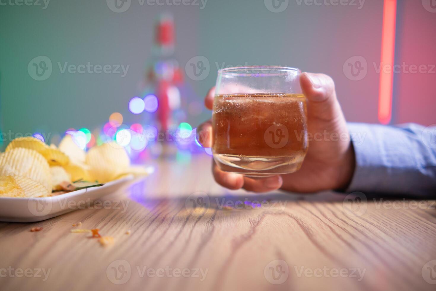 businessman sits and holds glass of liquor in his hand to drink relieve stress after experiencing problems in business. businessman drinking alcohol relieve stress from failed business venture. photo