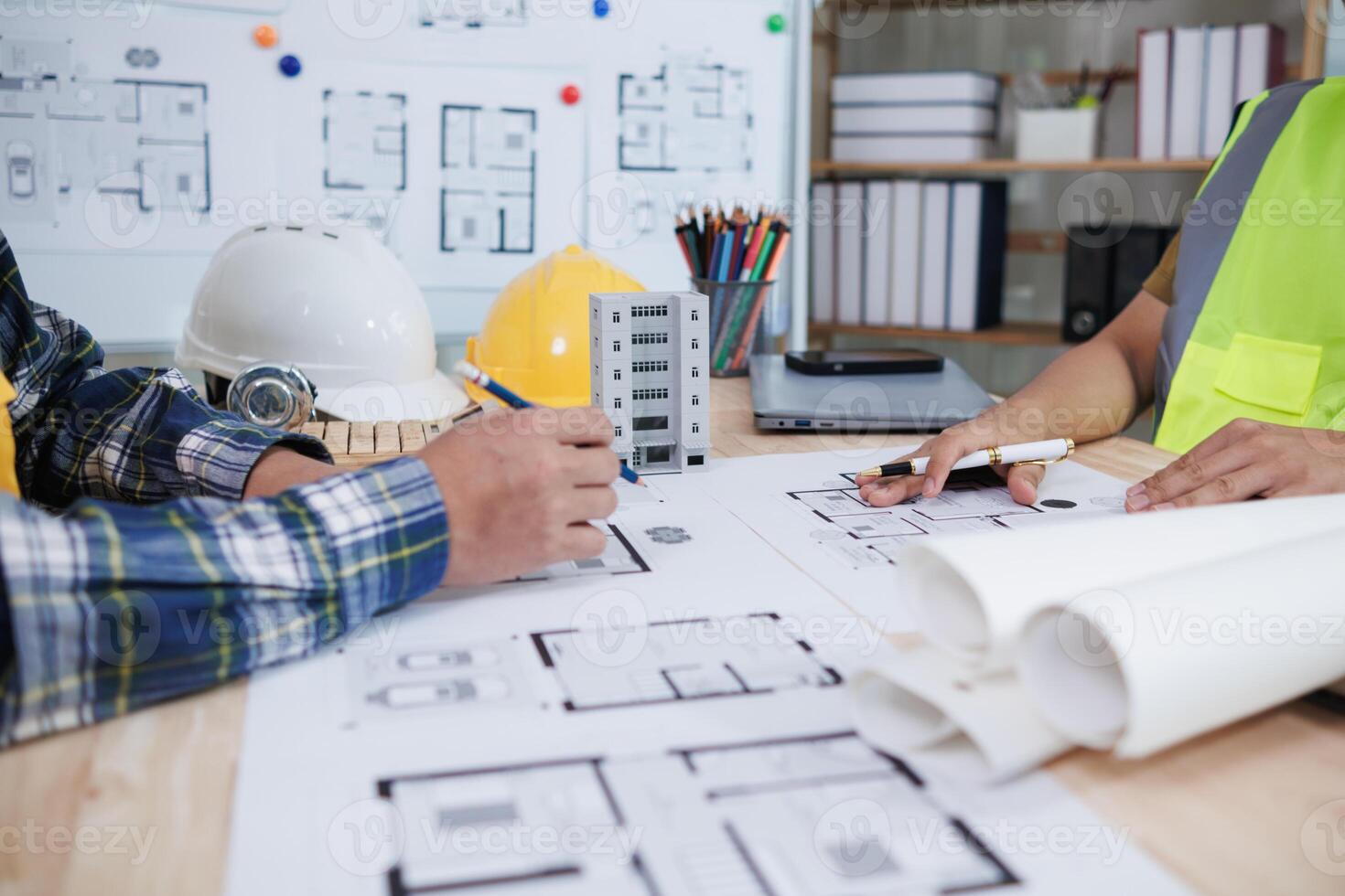 engineering is currently discussing structural design issues with architects to review plans to suit construction and stability of building. concept joint consultation between engineers and architects photo