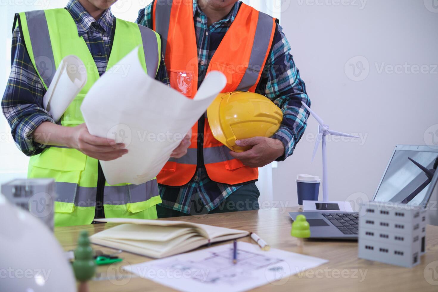 engineering is currently discussing structural design issues with architects to review plans to suit construction and stability of building. concept joint consultation between engineers and architects photo