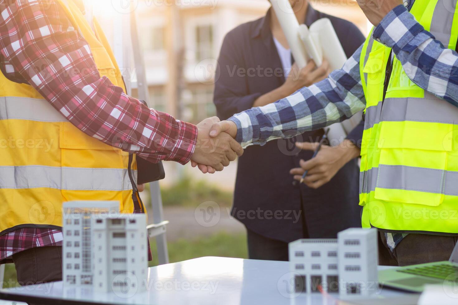 Engineers are reviewing plans from architects to prepare to install solar panels and wind turbines on the building to efficiently produce electricity using the concept of green energy from solar cells photo