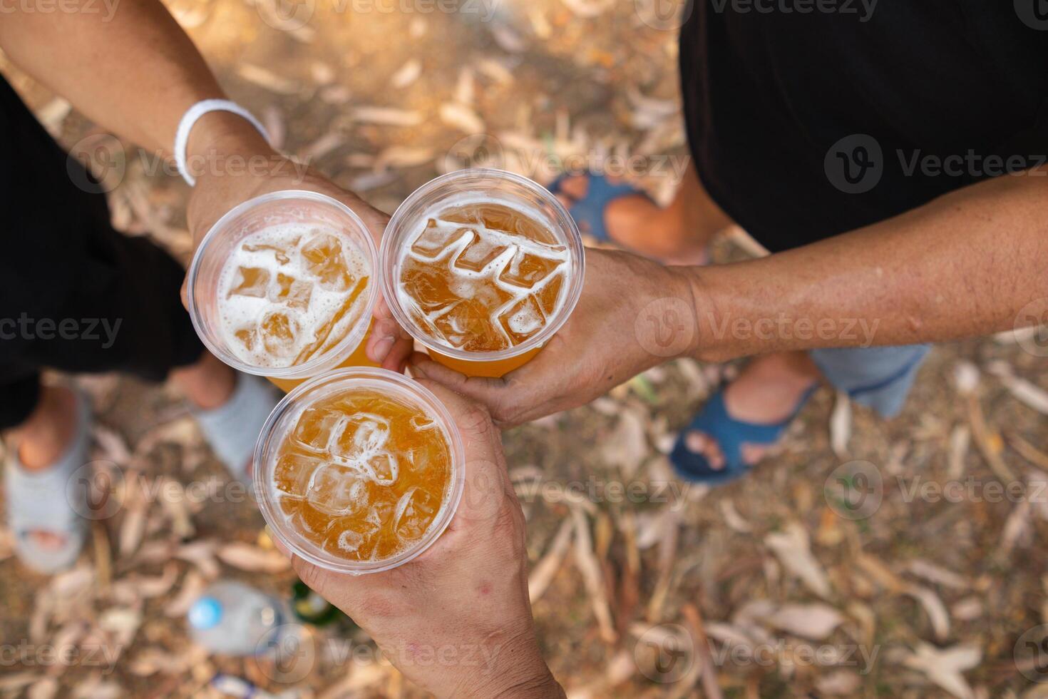 Beer, served in glasses, is a popular alcoholic drink around the world and is often used as a celebratory drink during festivals. Beer was served with ice in beer glasses because of the hot weather. photo