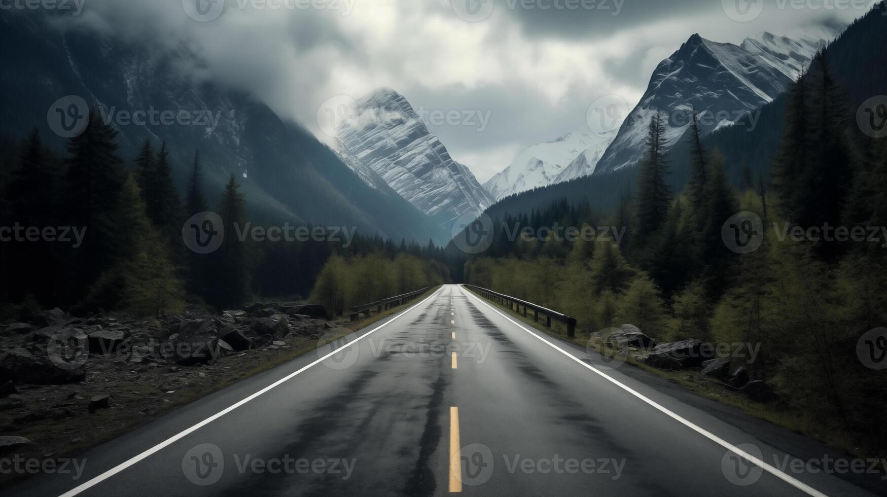 an empty road in the mountains with trees and mountains photo