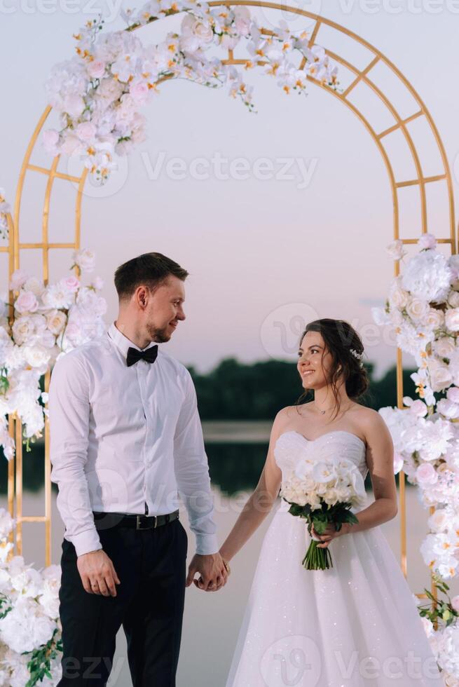 bride and groom against the backdrop of a yellow sunset photo