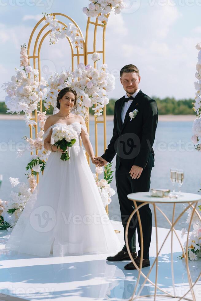 wedding ceremony of the newlyweds on the pier photo