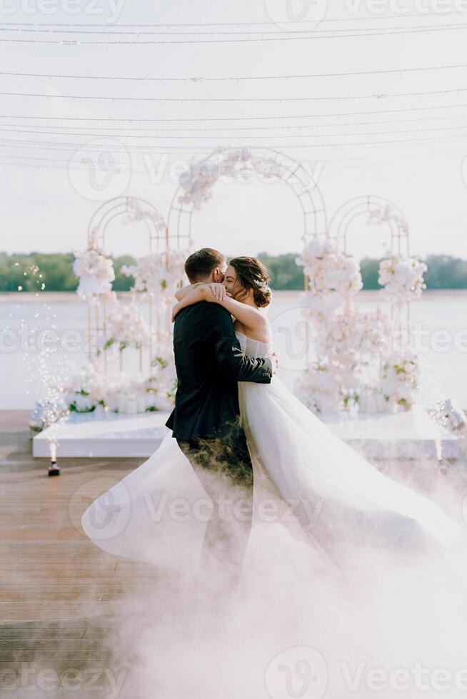 the first dance of the bride and groom inside a restaurant photo