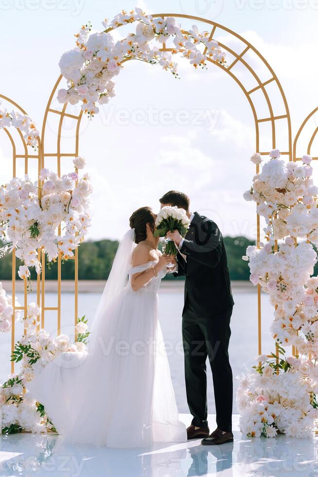 wedding ceremony of the newlyweds on the pier photo