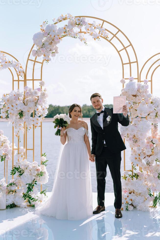 wedding ceremony of the newlyweds on the pier photo
