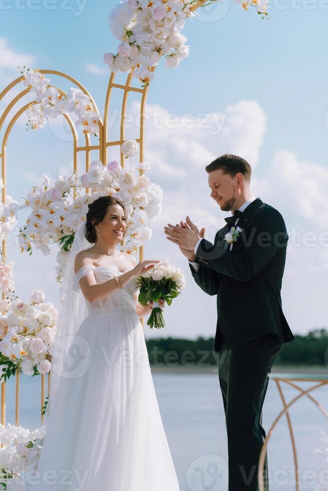 wedding ceremony of the newlyweds on the pier photo