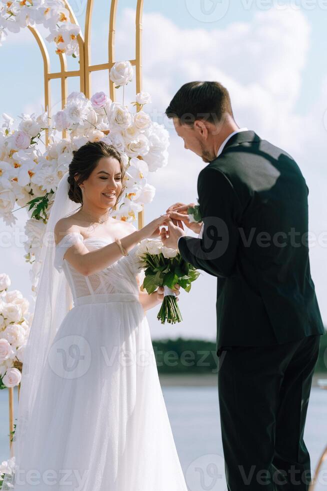 wedding ceremony of the newlyweds on the pier photo