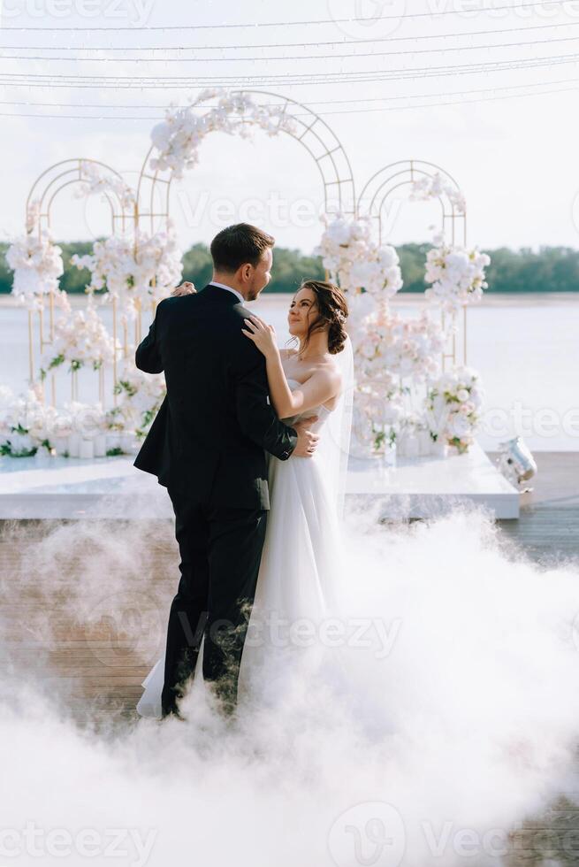 the first dance of the bride and groom inside a restaurant photo