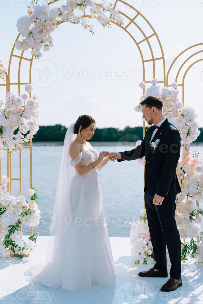 wedding ceremony of the newlyweds on the pier photo