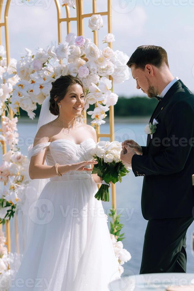 wedding ceremony of the newlyweds on the pier photo