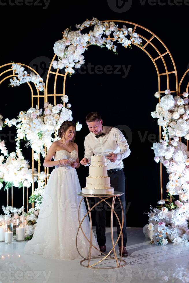 newlyweds happily cut and taste the wedding cak photo