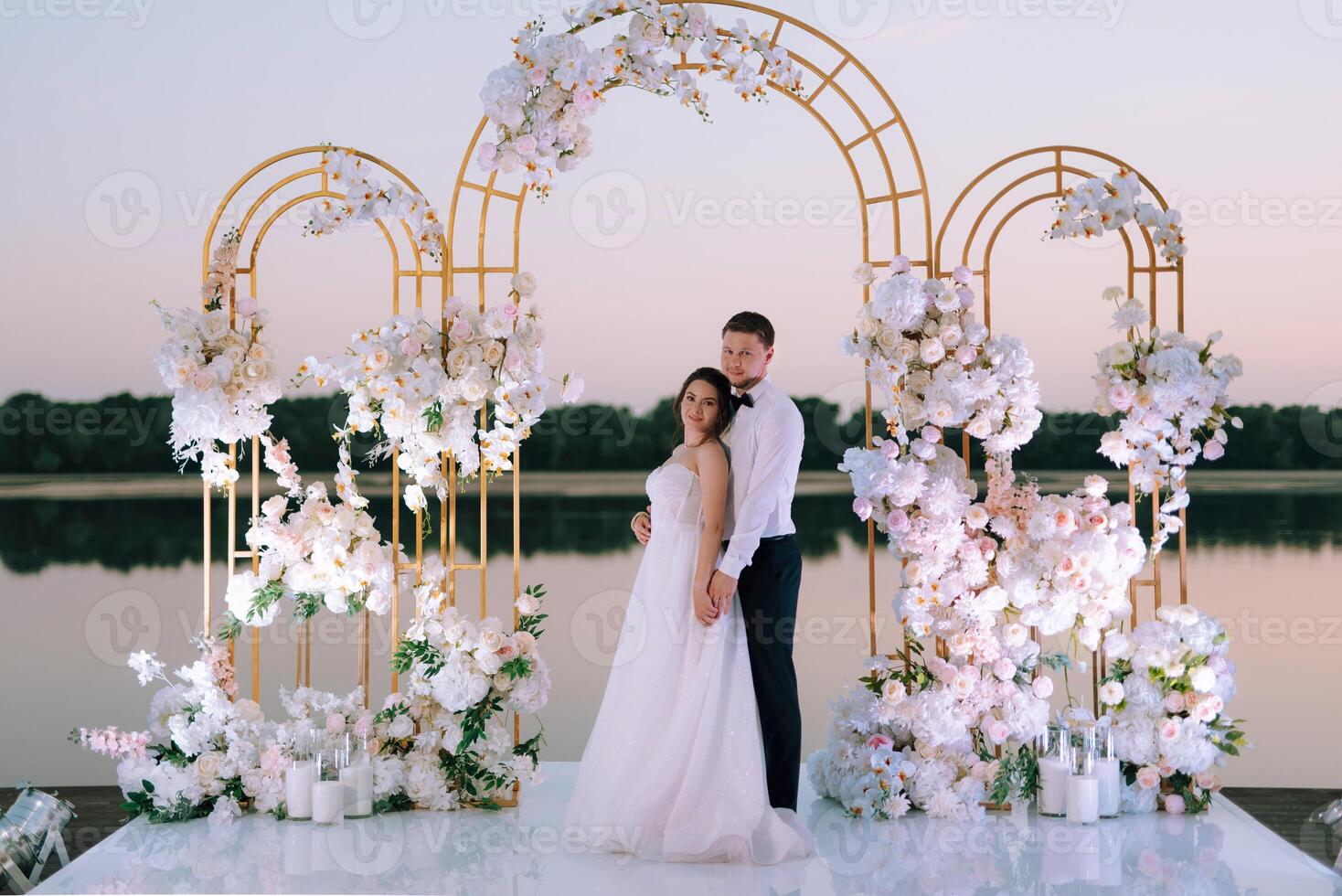 bride and groom against the backdrop of a yellow sunset photo