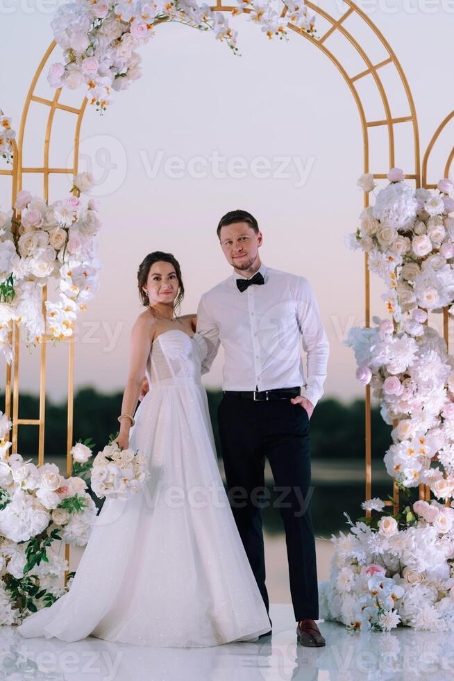 bride and groom against the backdrop of a yellow sunset photo