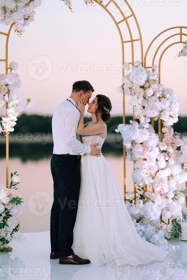 bride and groom against the backdrop of a yellow sunset photo