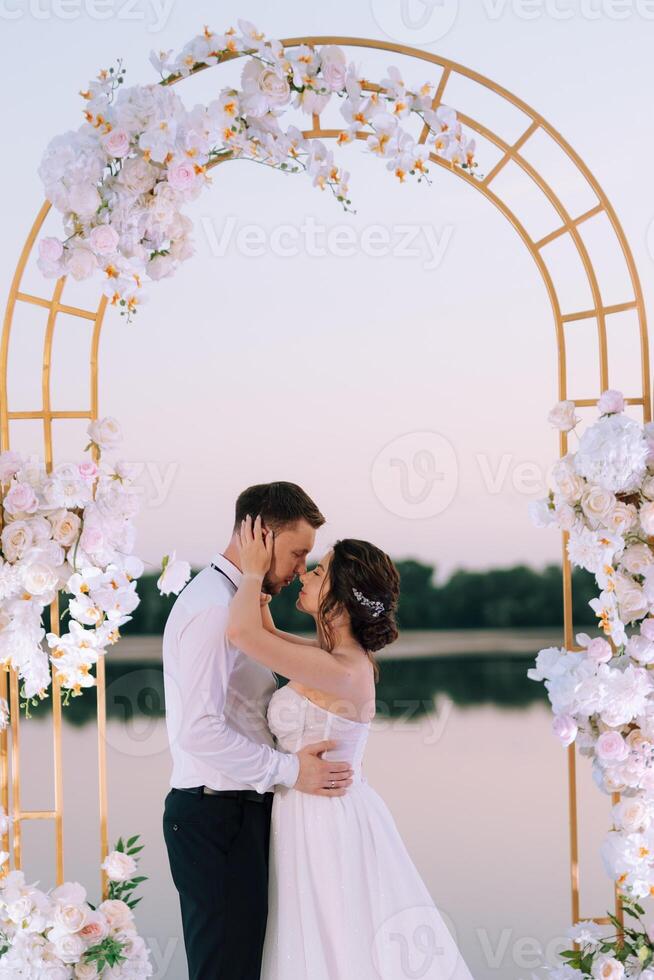 bride and groom against the backdrop of a yellow sunset photo