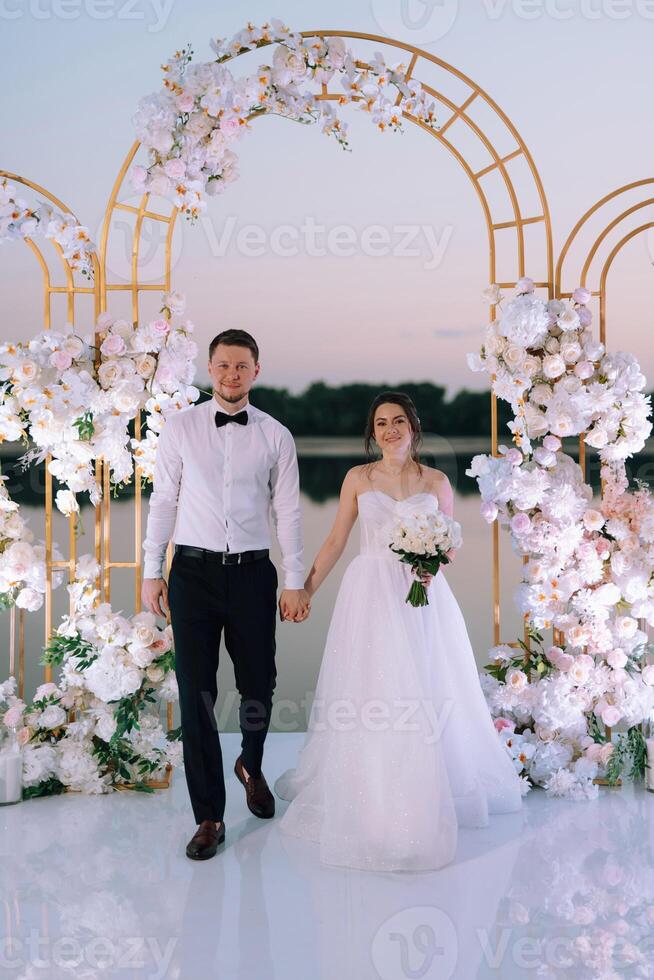 bride and groom against the backdrop of a yellow sunset photo