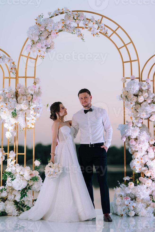 bride and groom against the backdrop of a yellow sunset photo