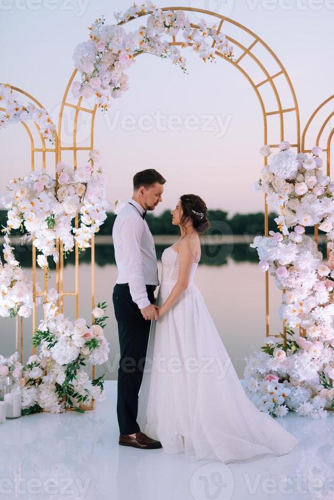 bride and groom against the backdrop of a yellow sunset photo